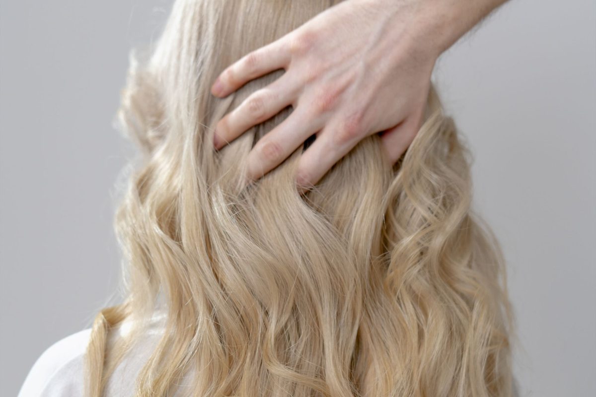Long hair finished in soft waves after a colour and cut