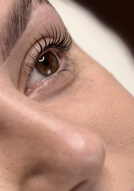 Close-up of a finished lash lift, showing lifted, defined natural lashes