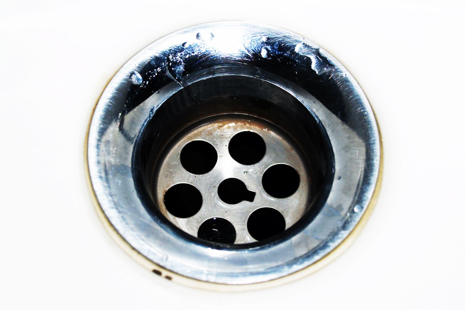 Close-up of a chrome sink waste and plughole