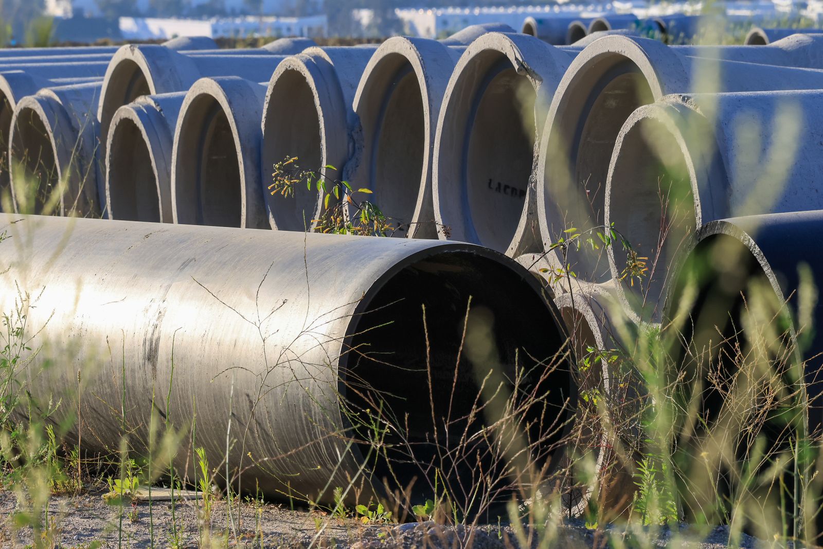 Concrete drainage pipes stacked ready to be installed