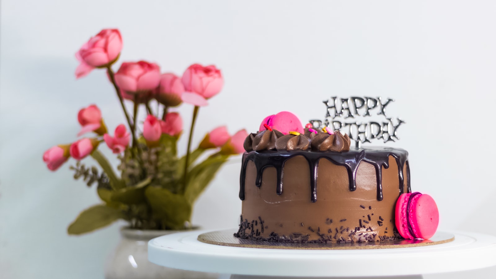 Chocolate celebration cake finished with a single pink sugar rose