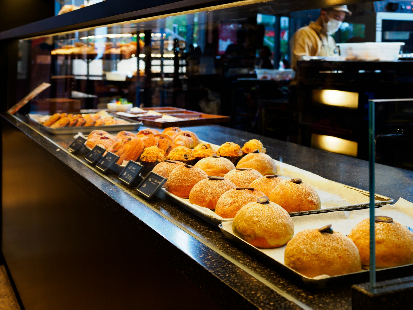 Display case filled with an assortment of finished pastries and bakes