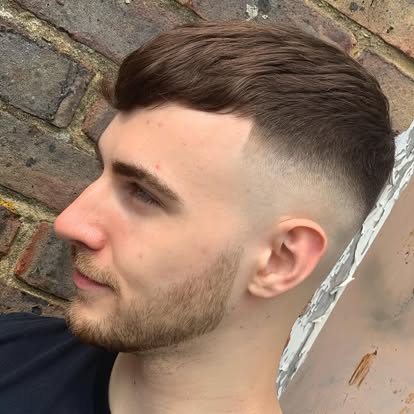 Side-swept quiff haircut with tapered fade, side profile