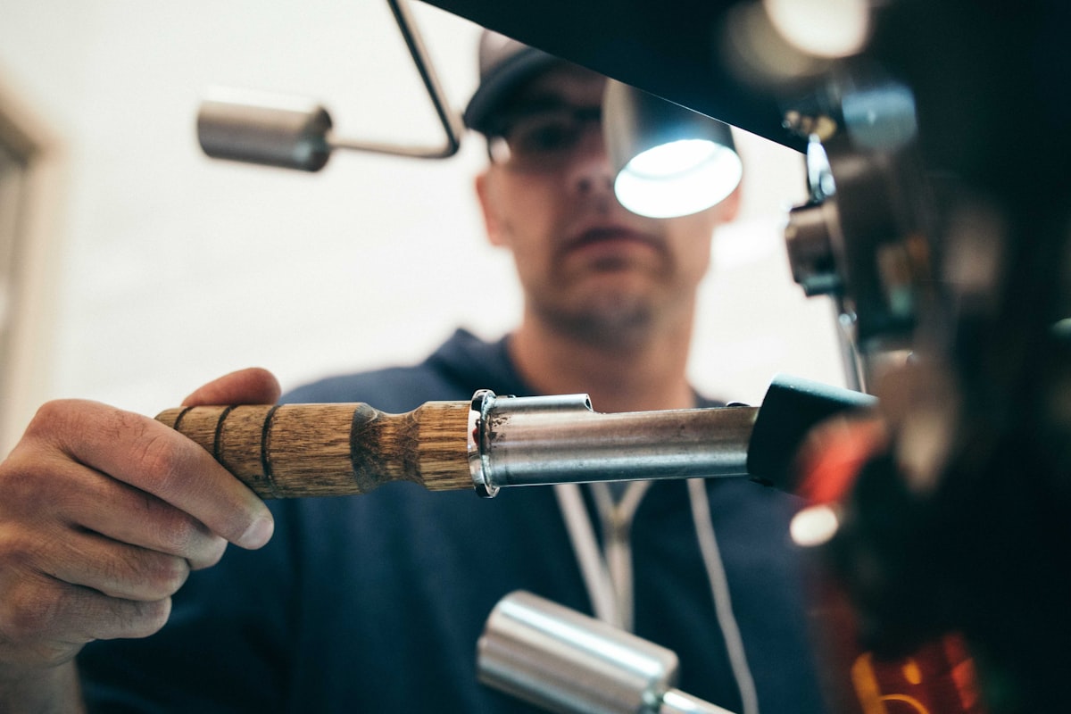 Plumber working on pipework under a kitchen sink