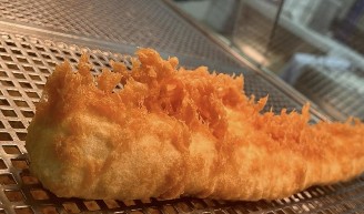 Close-up of golden battered fish fresh from the fryer