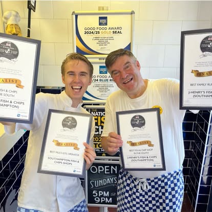 J-Henry's staff holding the Good Food Award Gold Seal and finalist certificates