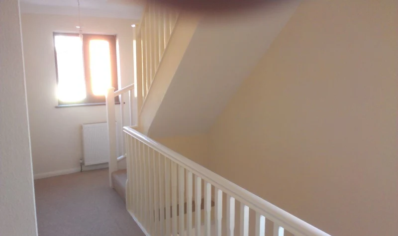 Freshly painted cream hallway and staircase landing