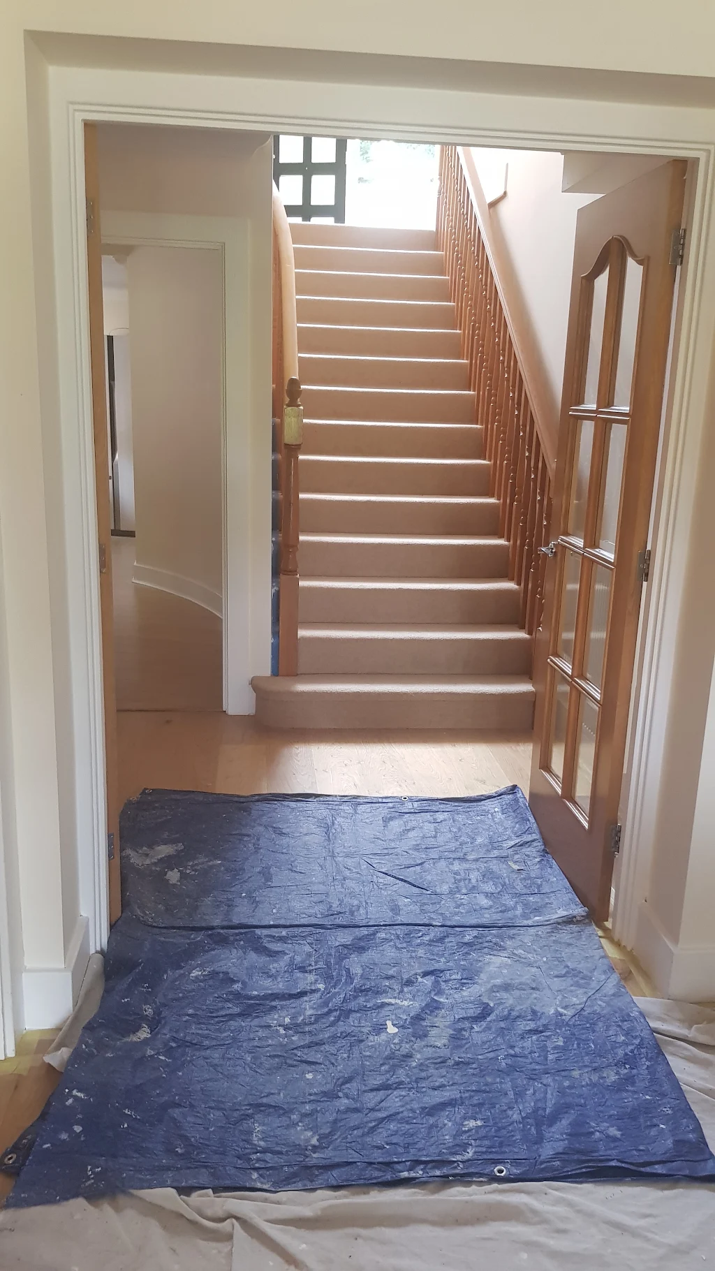Staircase carefully protected with dust sheets during a decorating job
