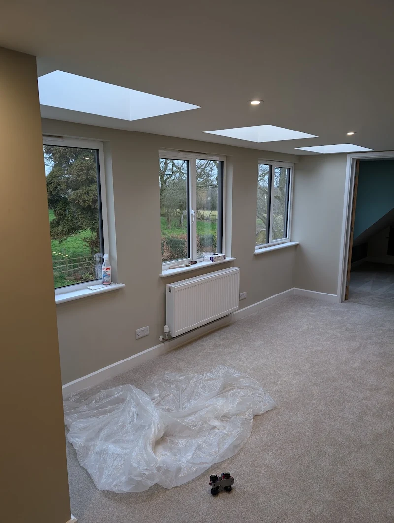 Bright, freshly painted loft room with skylights and large windows