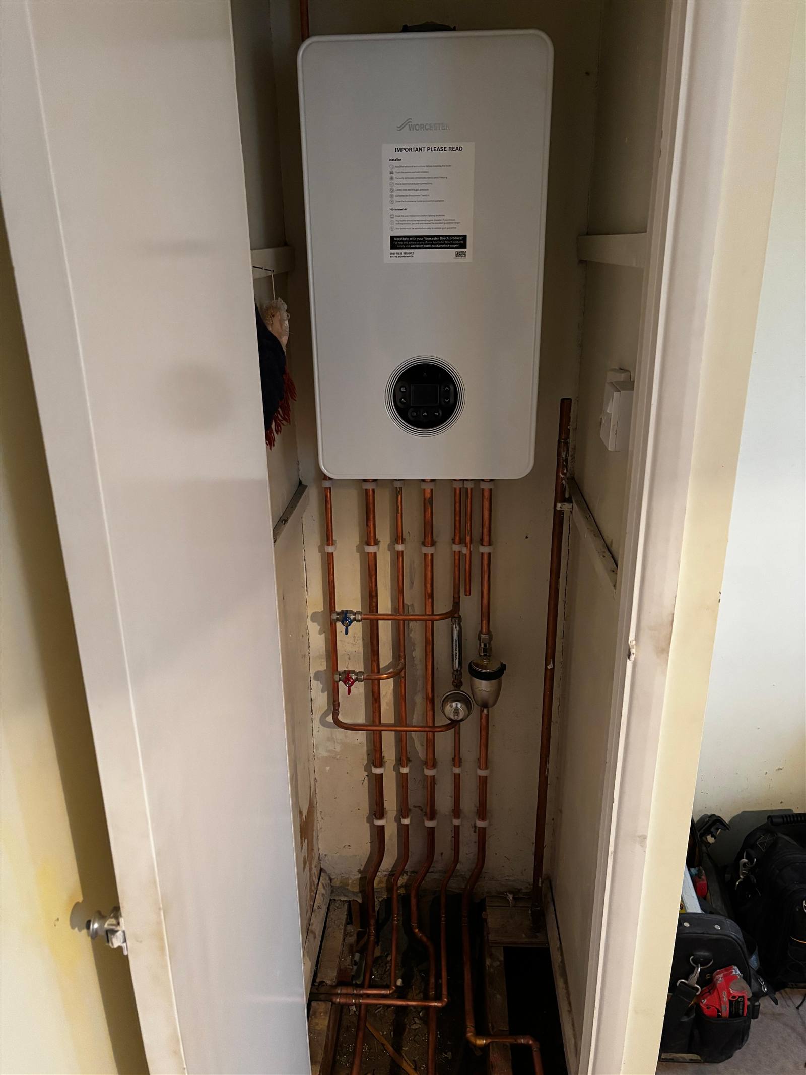 Completed boiler installation with copper pipework