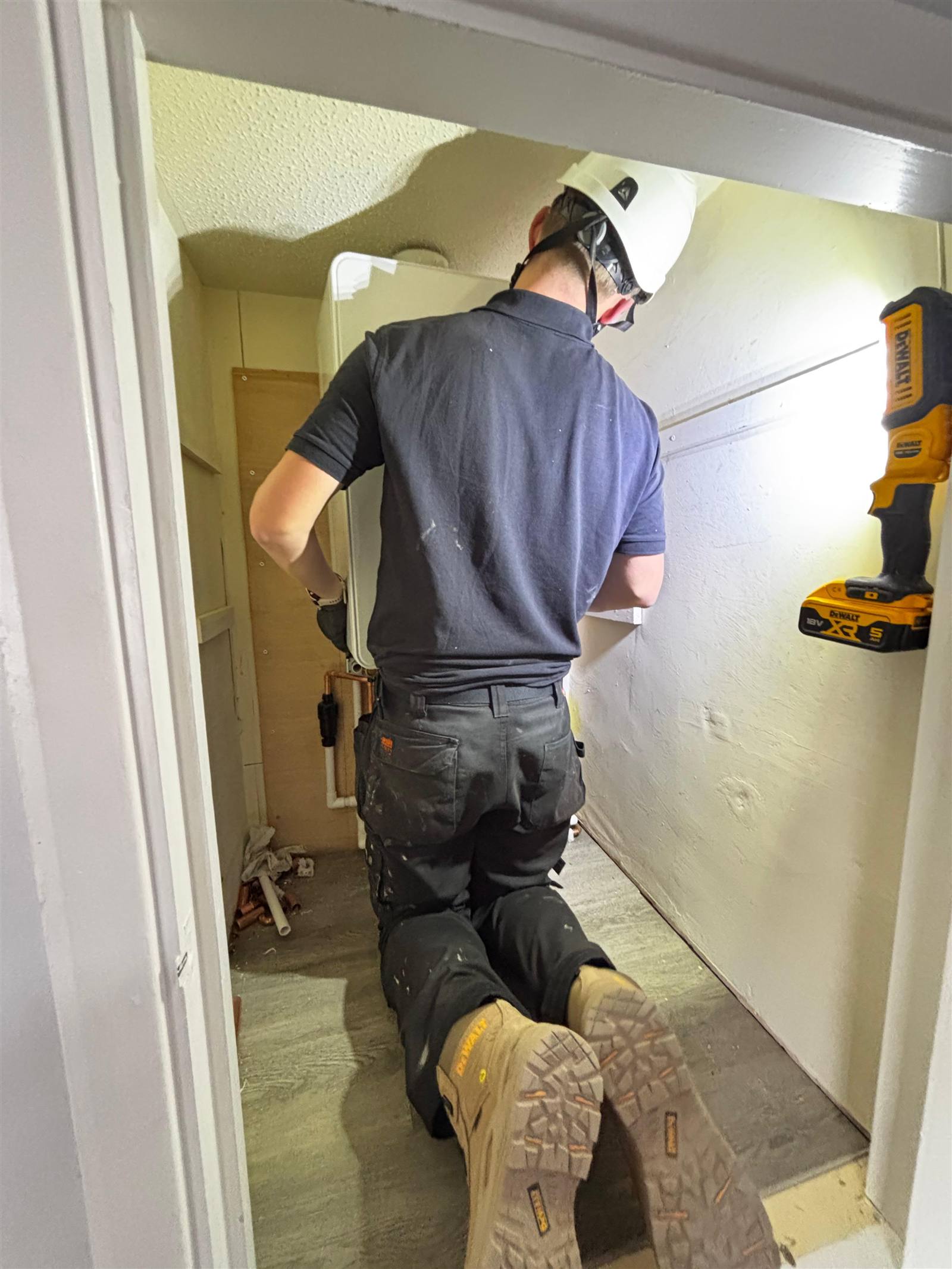 Living Waters engineer installing a boiler cupboard