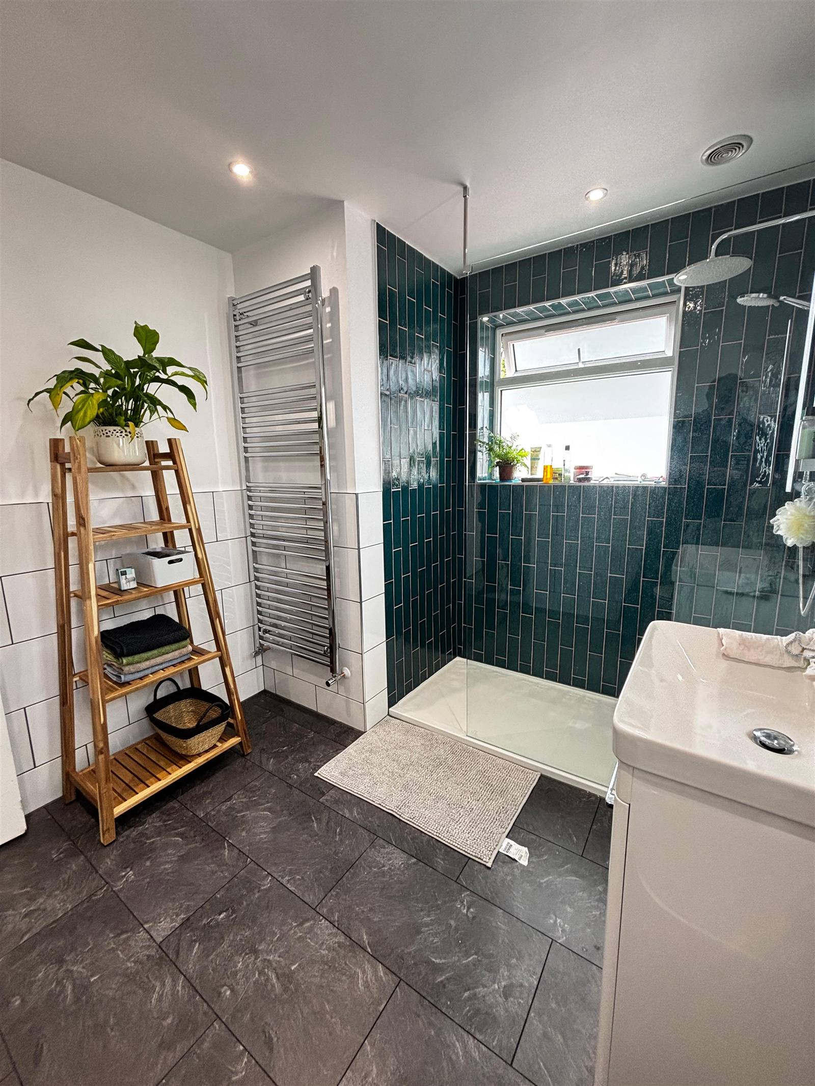 Finished bathroom with teal tiling