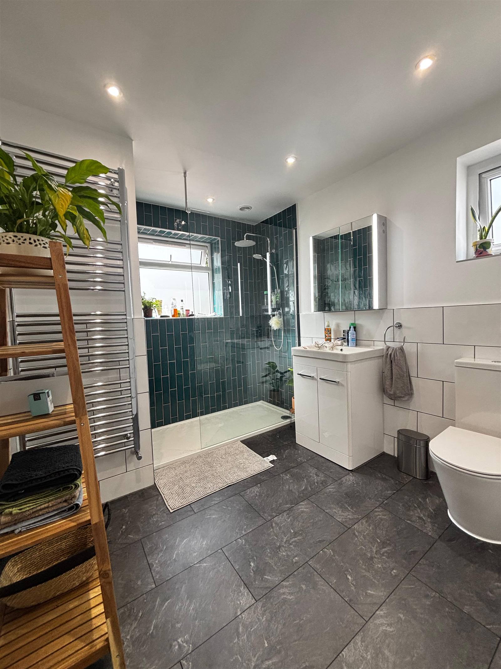 Bathroom renovation with teal tiling and walk-in shower