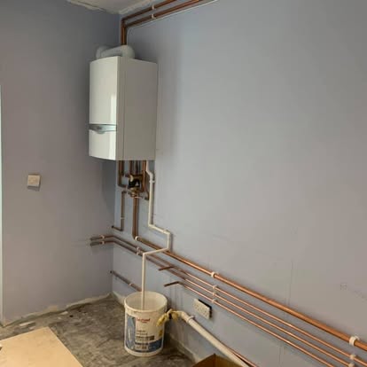 New boiler with neat copper pipework runs during a full refit
