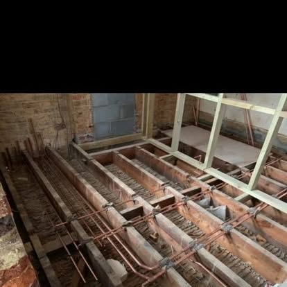 Central heating pipework laid across floor joists during a renovation