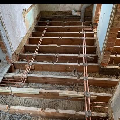 Copper heating pipework run across new floor joists