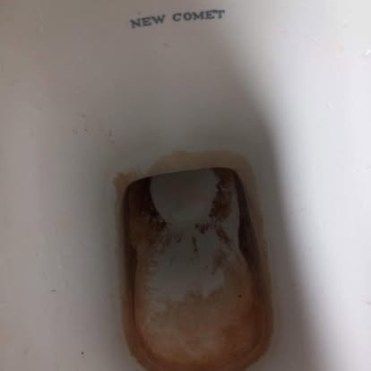 Toilet bowl with limescale staining before clean