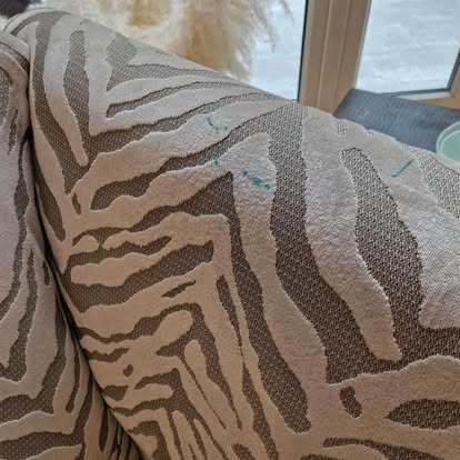 Upholstered chair fabric before clean, with visible stains