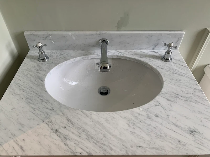 New chrome basin taps fitted to a marble vanity top
