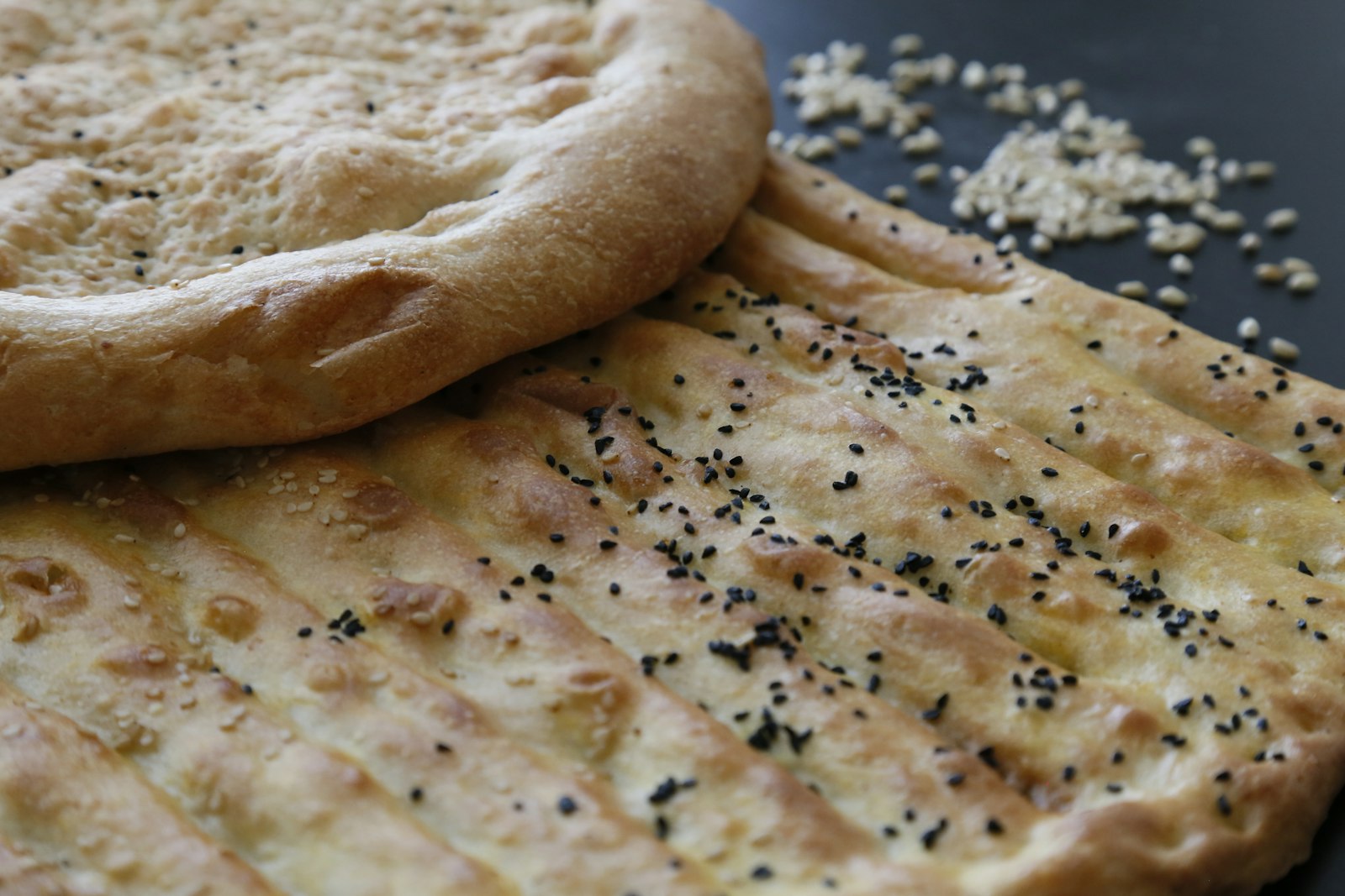 Naan bread cooking in a traditional tandoor oven
