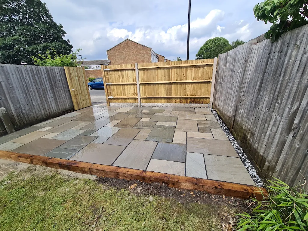 Side garden patio with a newly built timber fence panel and gate