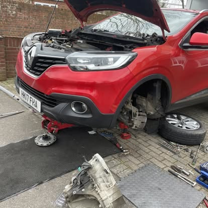 SC Services mechanic carrying out a mobile repair on a car in a customer's driveway, with the bonnet up and a wheel removed