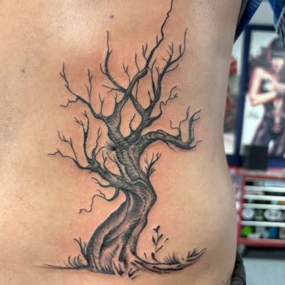 Fine line black and grey bare winter tree tattoo on ribs