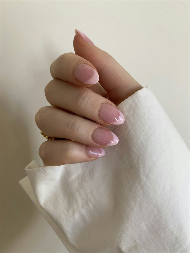 Almond nails with a glossy milky-pink gel finish