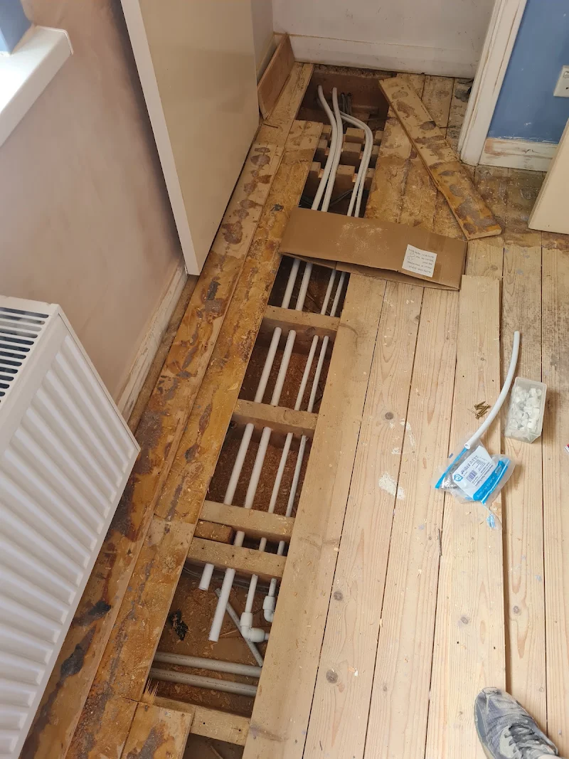 First-fix pipework run through floor joists during a renovation