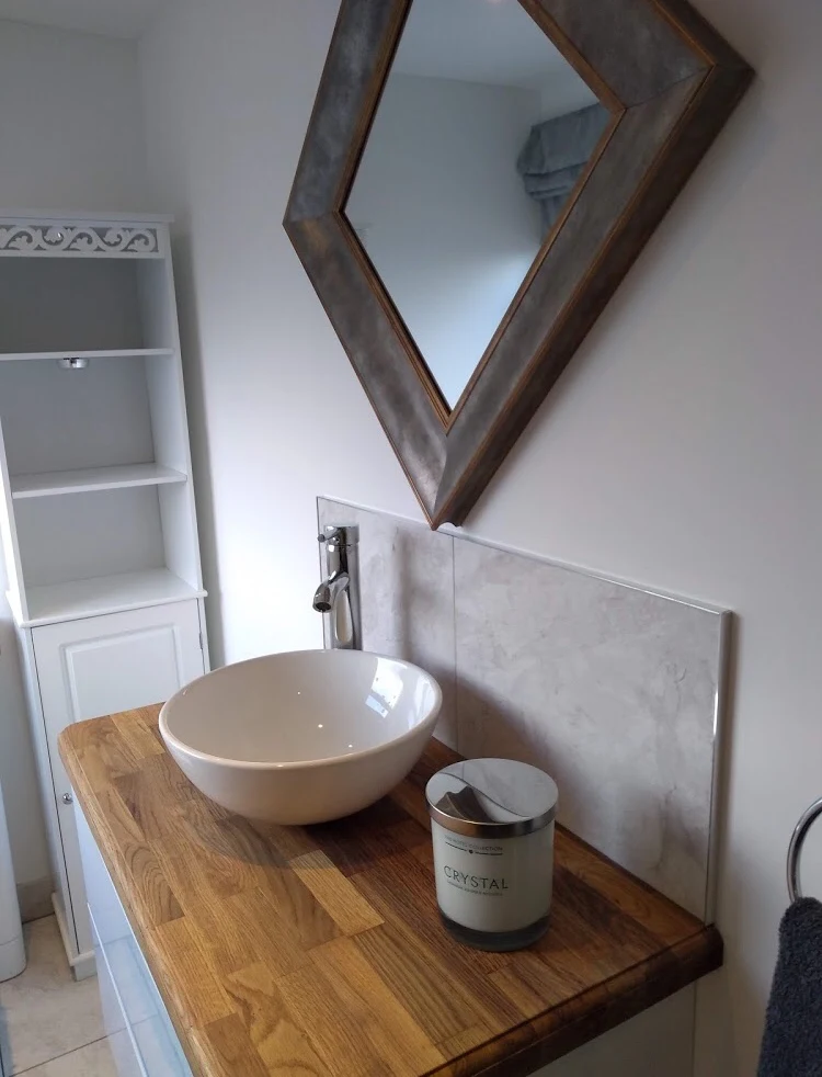 Countertop basin and chrome tap on an oak vanity unit