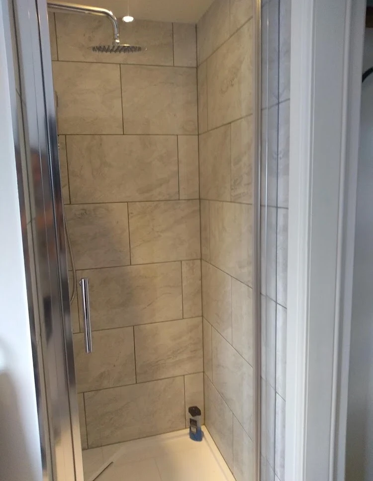 Fully tiled shower enclosure with rainfall shower head
