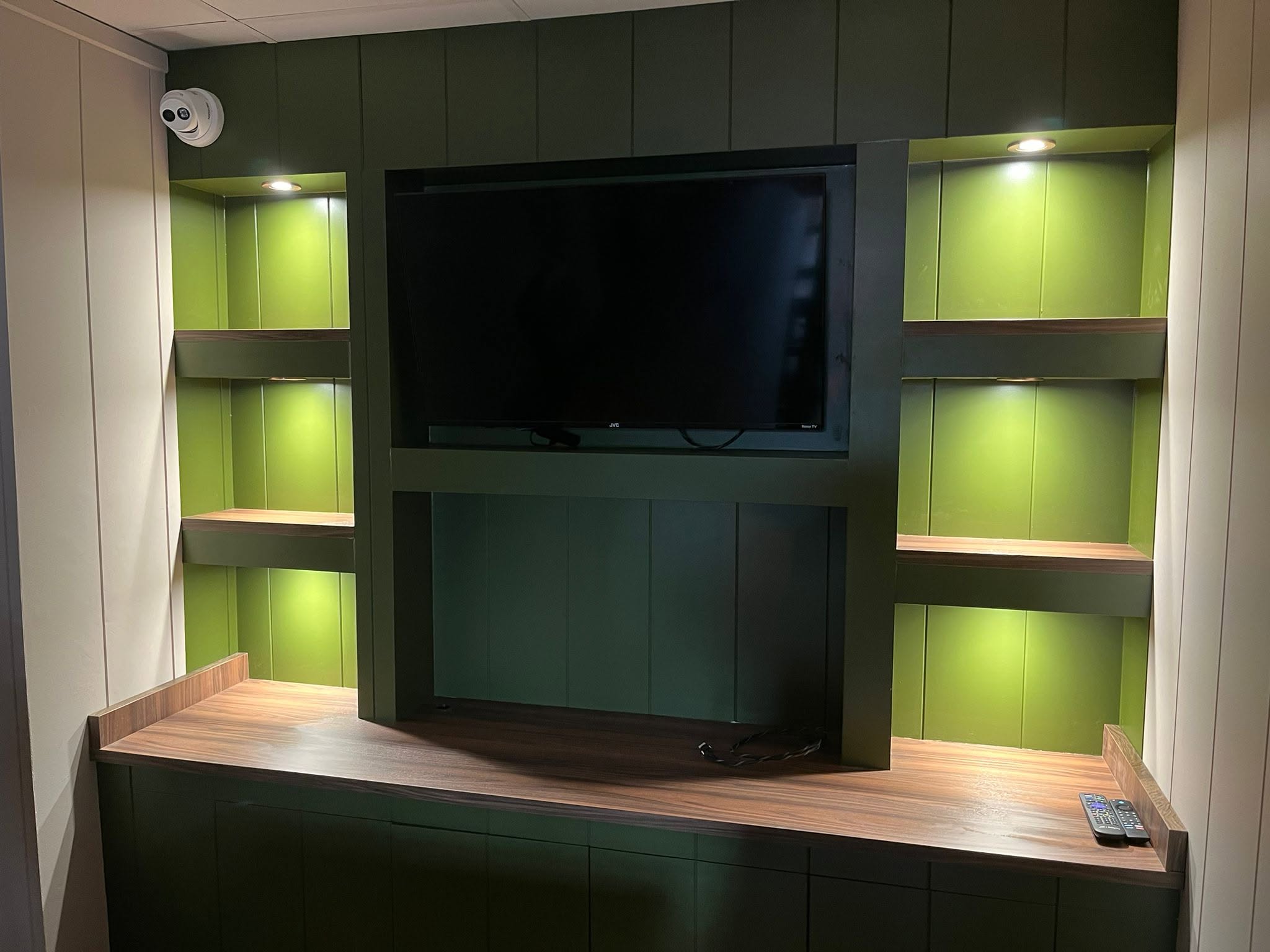 Illuminated green media wall joinery in a commercial fit-out