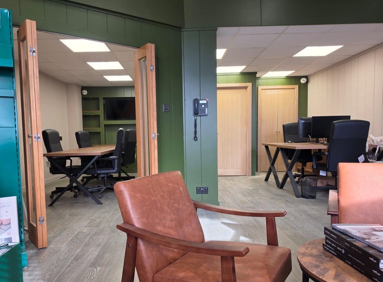 TPO Projects office and showroom with flooring displays and bespoke green panelling