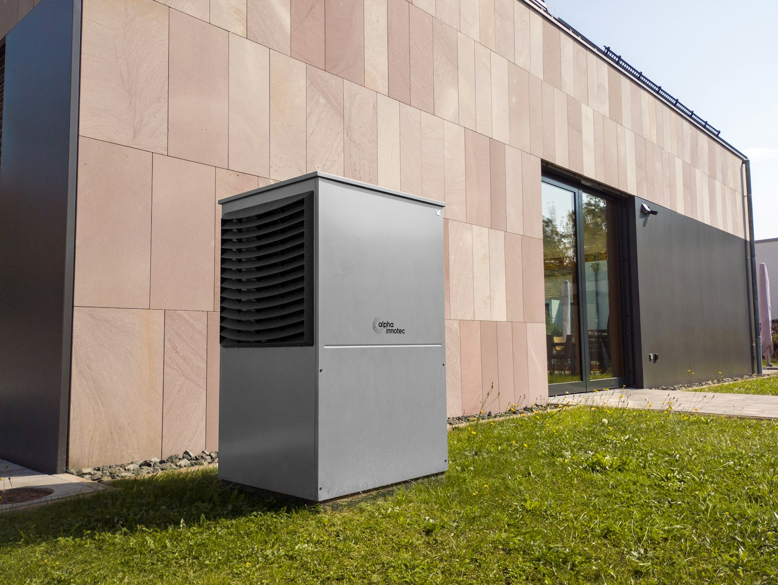 Air source heat pump installed beside a modern home