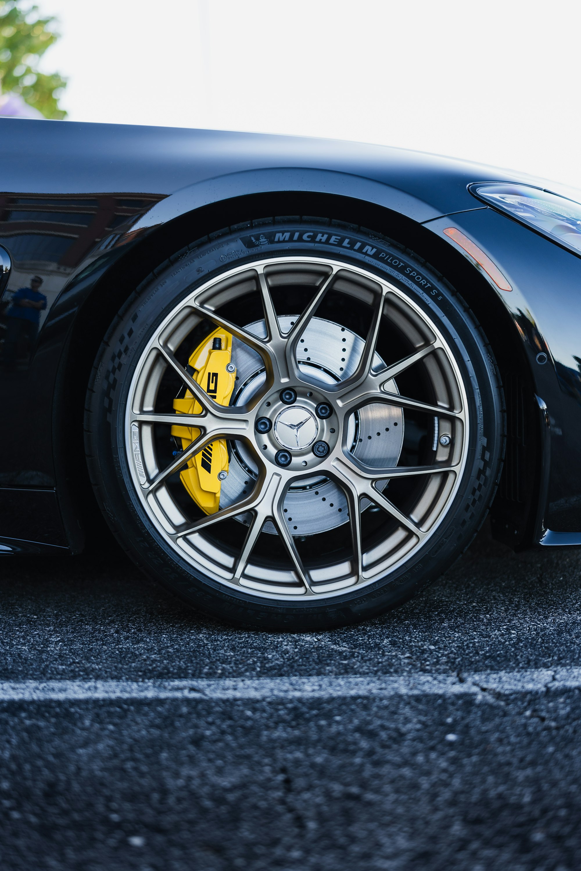 Clean alloy wheel and yellow brake caliper close-up