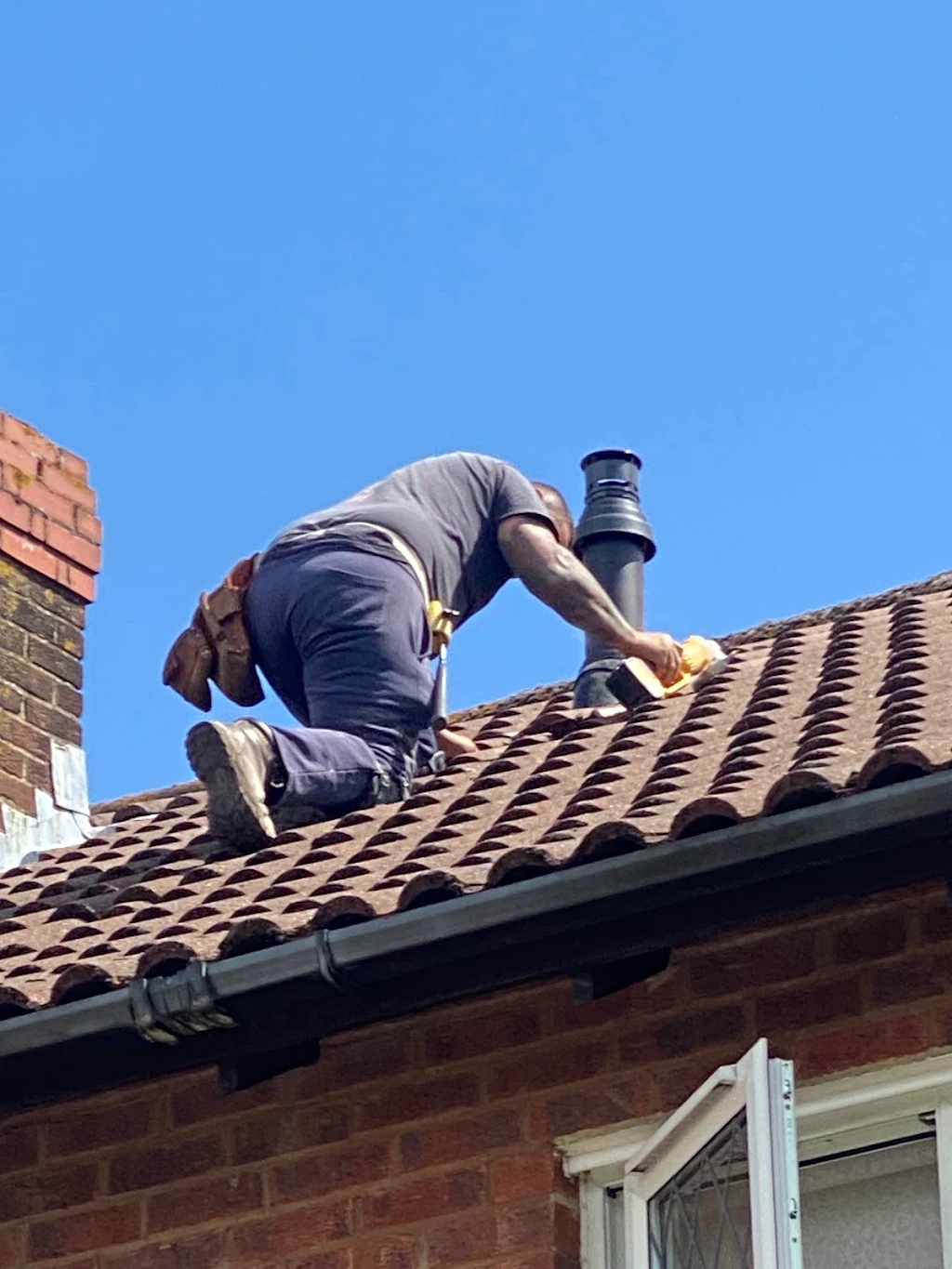 Engineer carrying out flue work on a roof