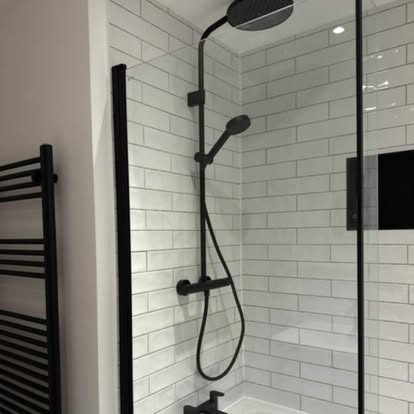Modern shower with matt black fixtures and metro tiles