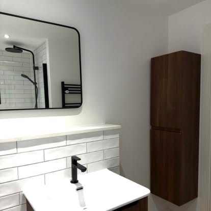 Renovated bathroom with new vanity unit and mirror